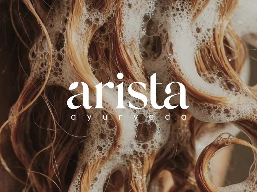 Arista Ayurveda logo over lathered hair