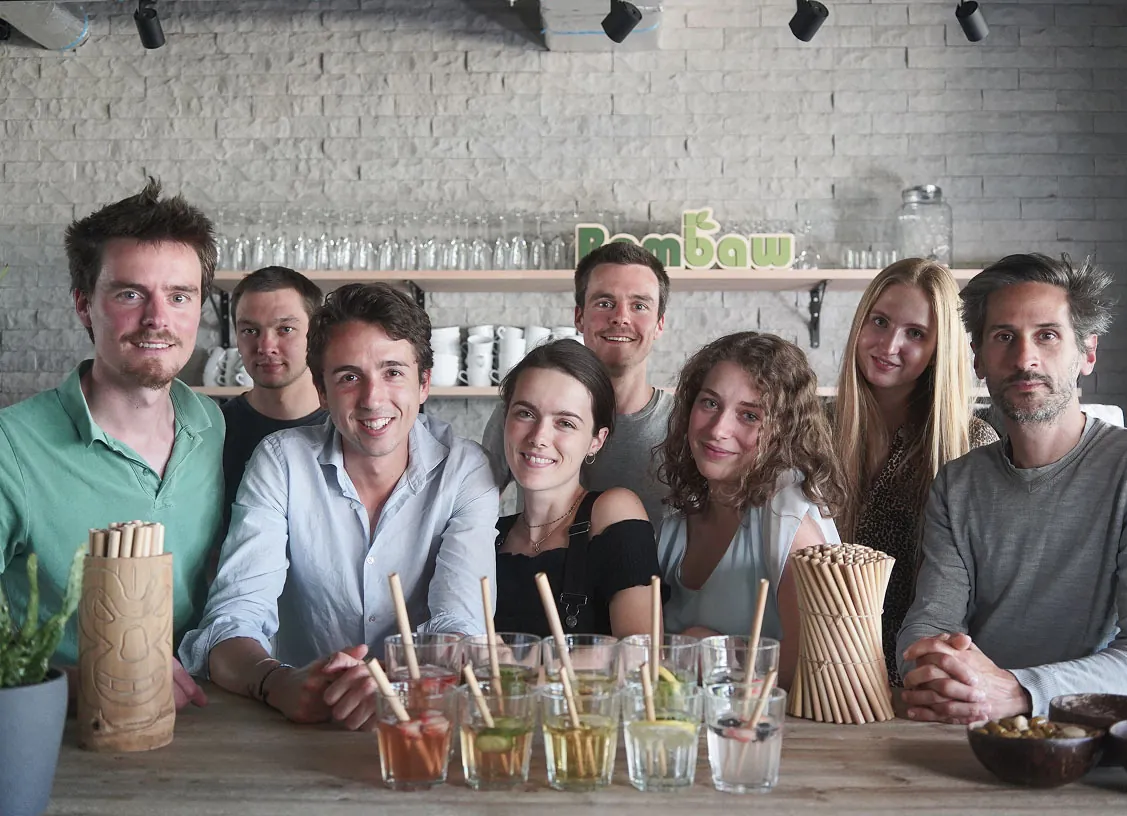 The Bambaw team behind a bar with drinks and bamboo straws